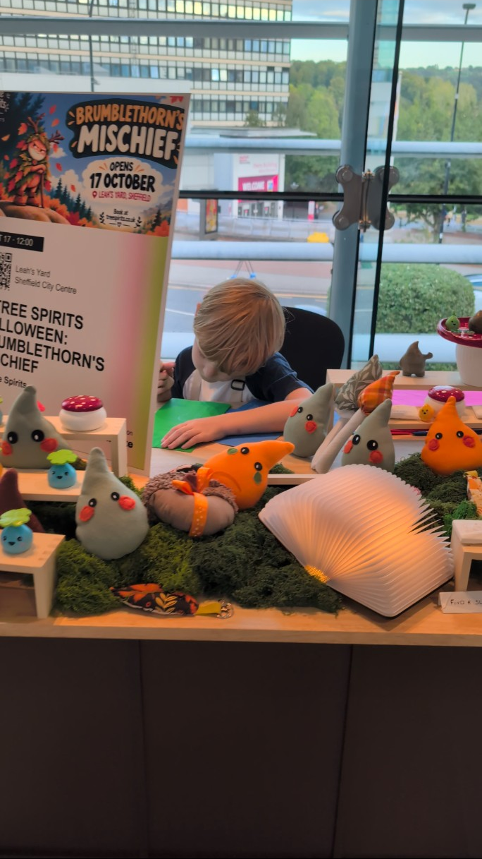 Handmade Tree Spirits, Oliver and a glowing storybook at the display.